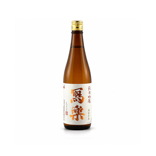 Front view of the premium Sharaku Junmai Ginjo bottle, featuring the elegant white label with distinct black calligraphy and red brewery seal.